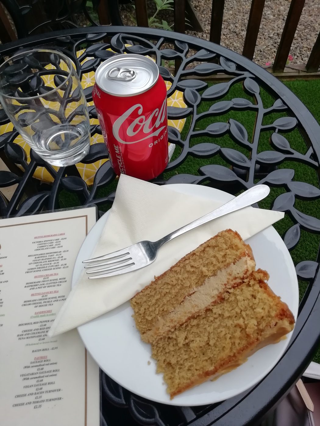 A slice of sponge cake with a can of cola